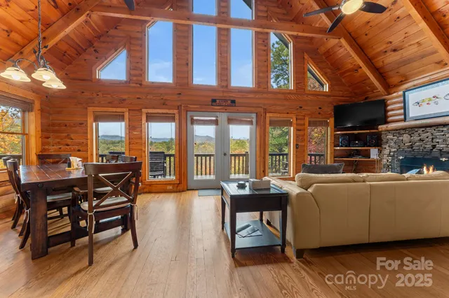 a living room with furniture a wooden floor and a floor to ceiling window