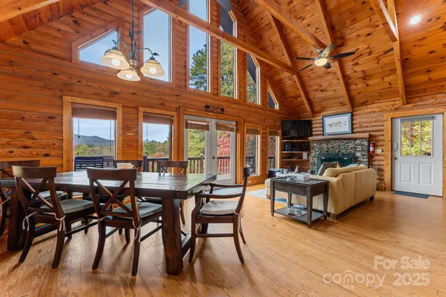 a view of a patio with couches and table and chairs with wooden floor