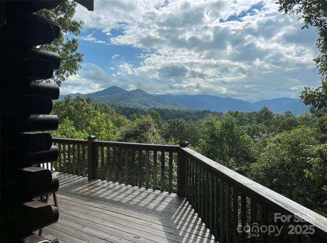 a balcony with wooden floor and city view