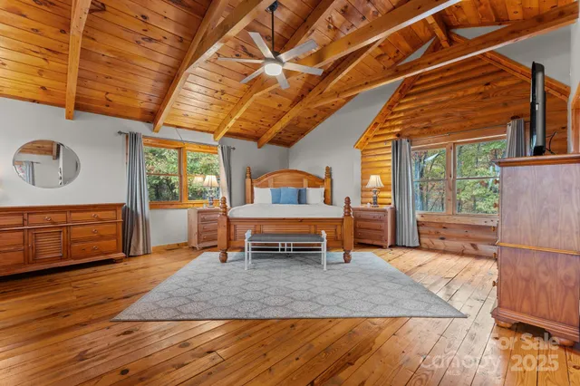 a bedroom with furniture and a wooden floor