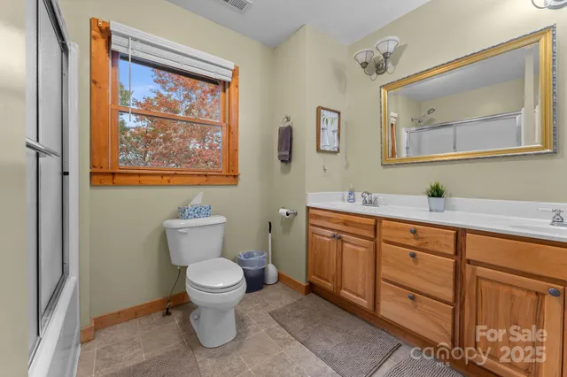 a bathroom with a toilet a sink and mirror