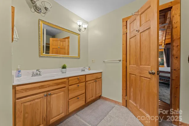 a bathroom with a double vanity sink and a mirror