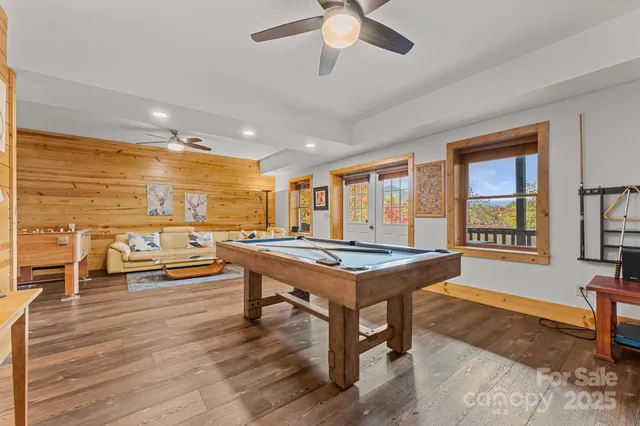 a room with furniture pool table and windows