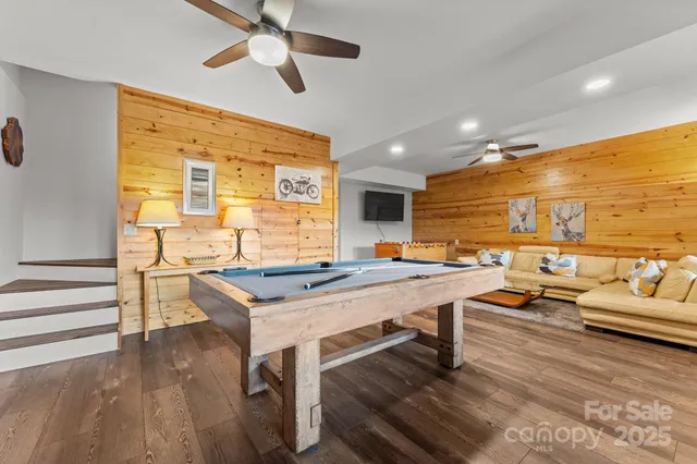 a view of a workspace with furniture and a floor to ceiling window
