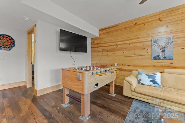 a bedroom with furniture and a flat screen tv