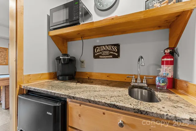 a kitchen with sink cabinets and granite counter top