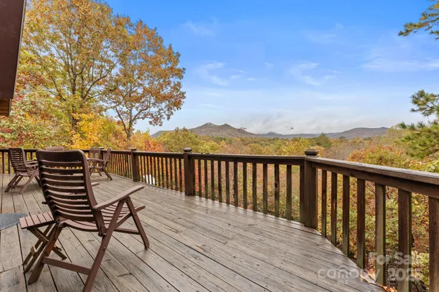 a view of balcony with wooden floor and fence