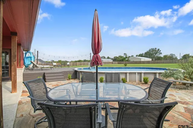 a view of a house with backyard porch and sitting area