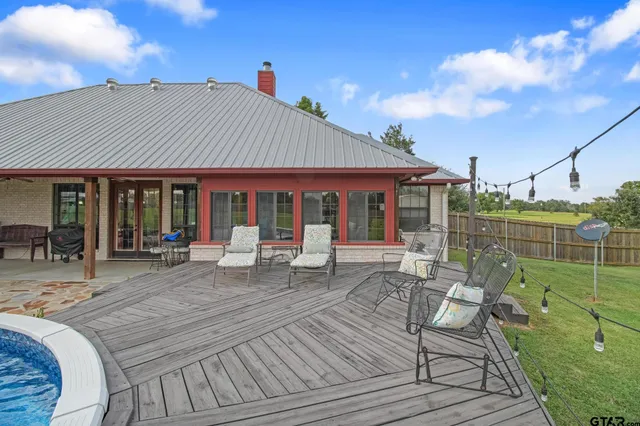 a view of a backyard with swimming pool
