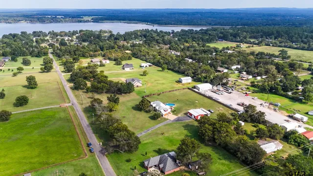 an aerial view of a house with swimming pool garden and patio