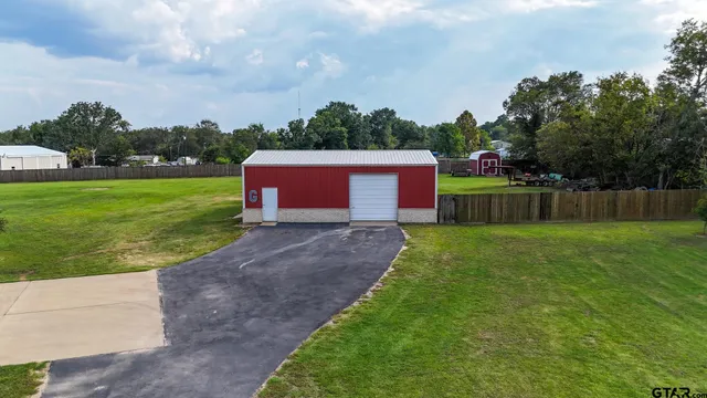 a car parked in front of a house with a yard