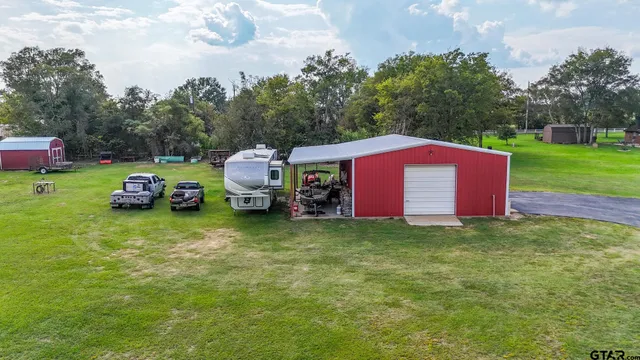 a aerial view of a house with garden space and lake view