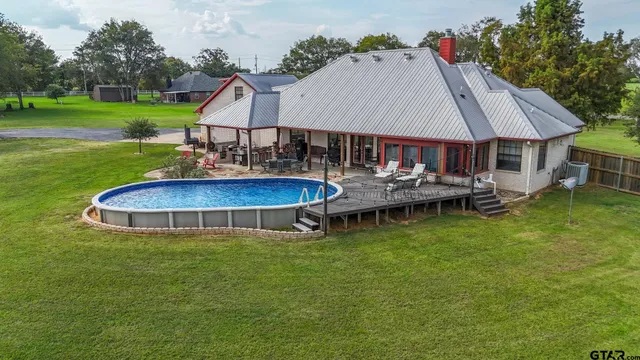 a living room with furniture a ceiling fan and a rug