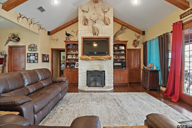 a living room with furniture a flat screen tv and a floor to ceiling window