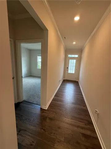 a view of hallway with wooden floor