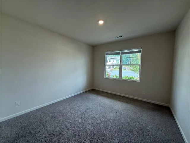 an empty room with windows and entrance