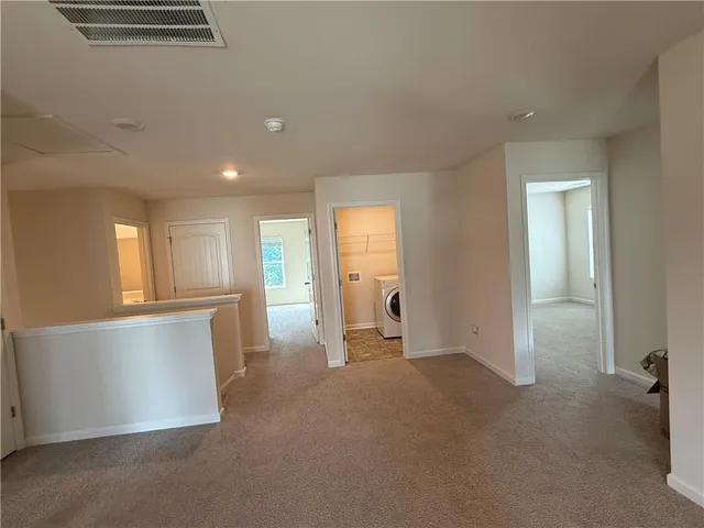 a view of a kitchen with a sink and cabinets