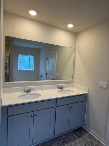 a bathroom with bathtub and window