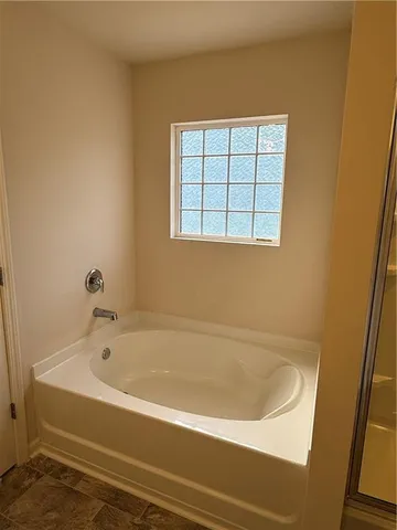 a bathroom with a glass shower door