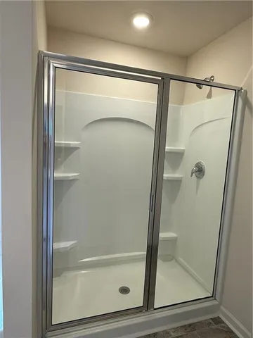 a white bath tub sitting next to a shower