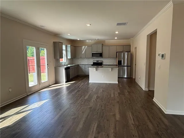 a view of kitchen with wooden floor and window