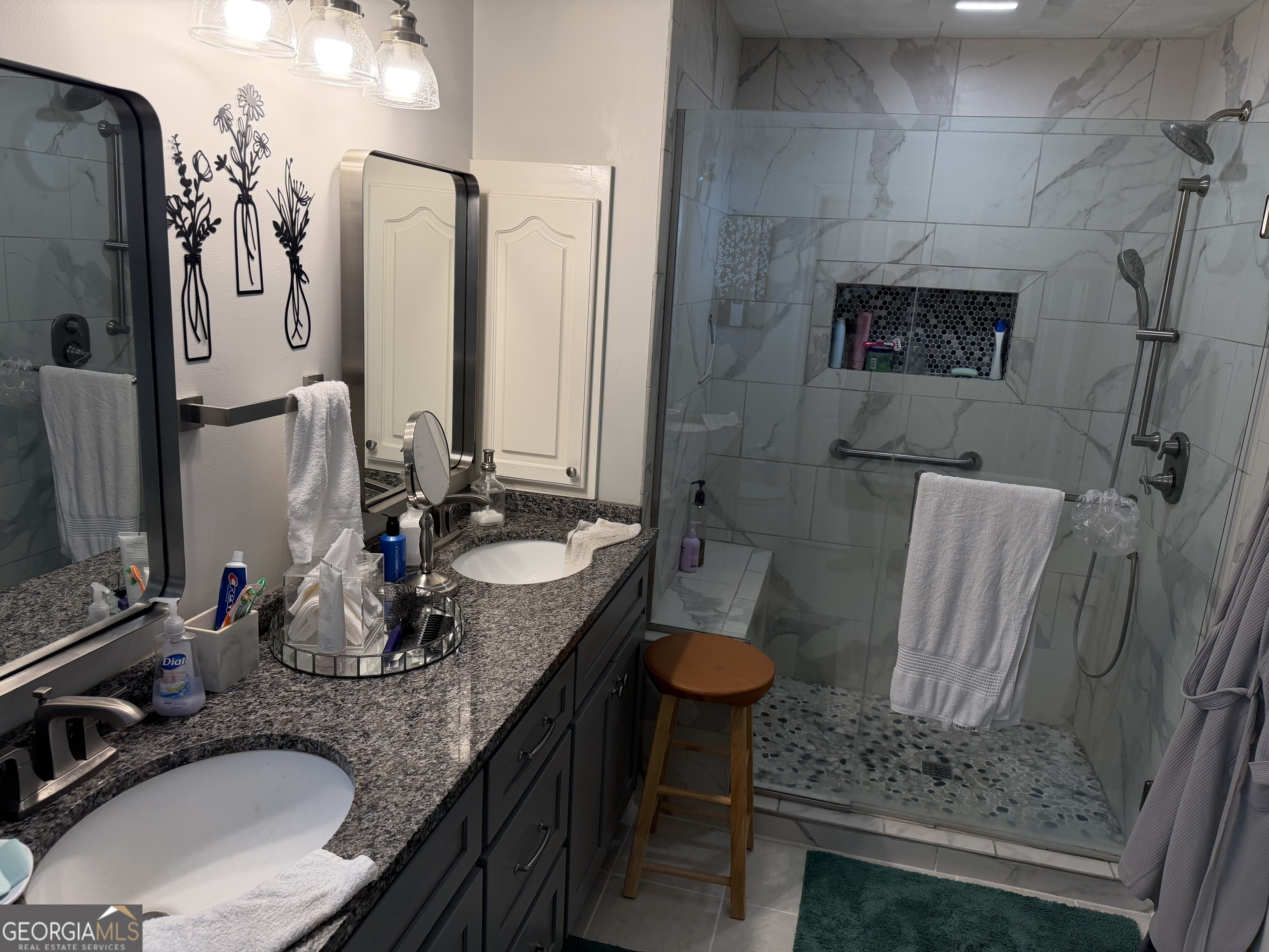 848 Tanglewood Circle Dublin, GA 31021 - Photo 15 of 21 a bathroom with a granite countertop sink a mirror and a shower
