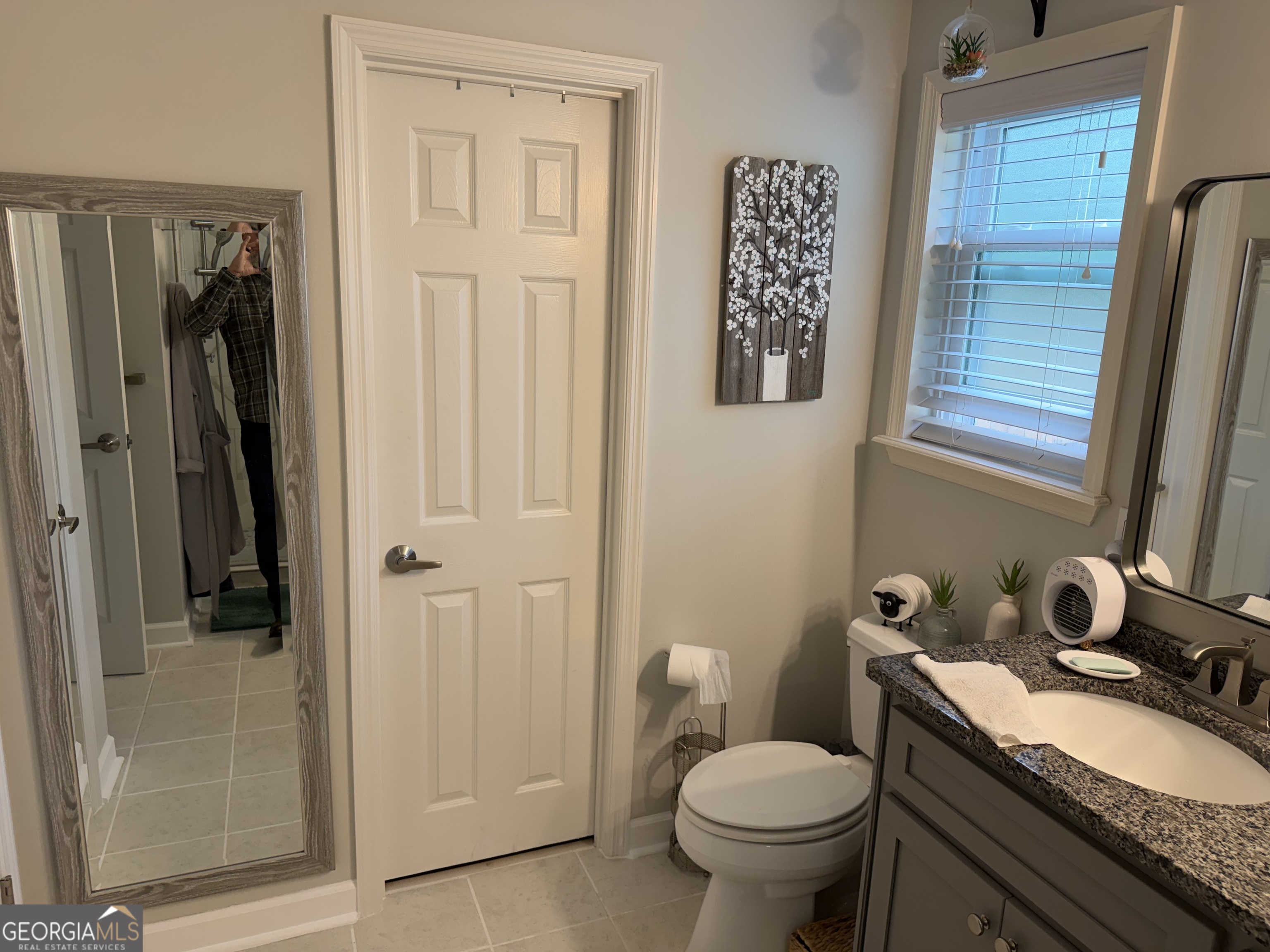 848 Tanglewood Circle Dublin, GA 31021 - Photo 17 of 21 a bathroom with a granite countertop toilet sink and shower