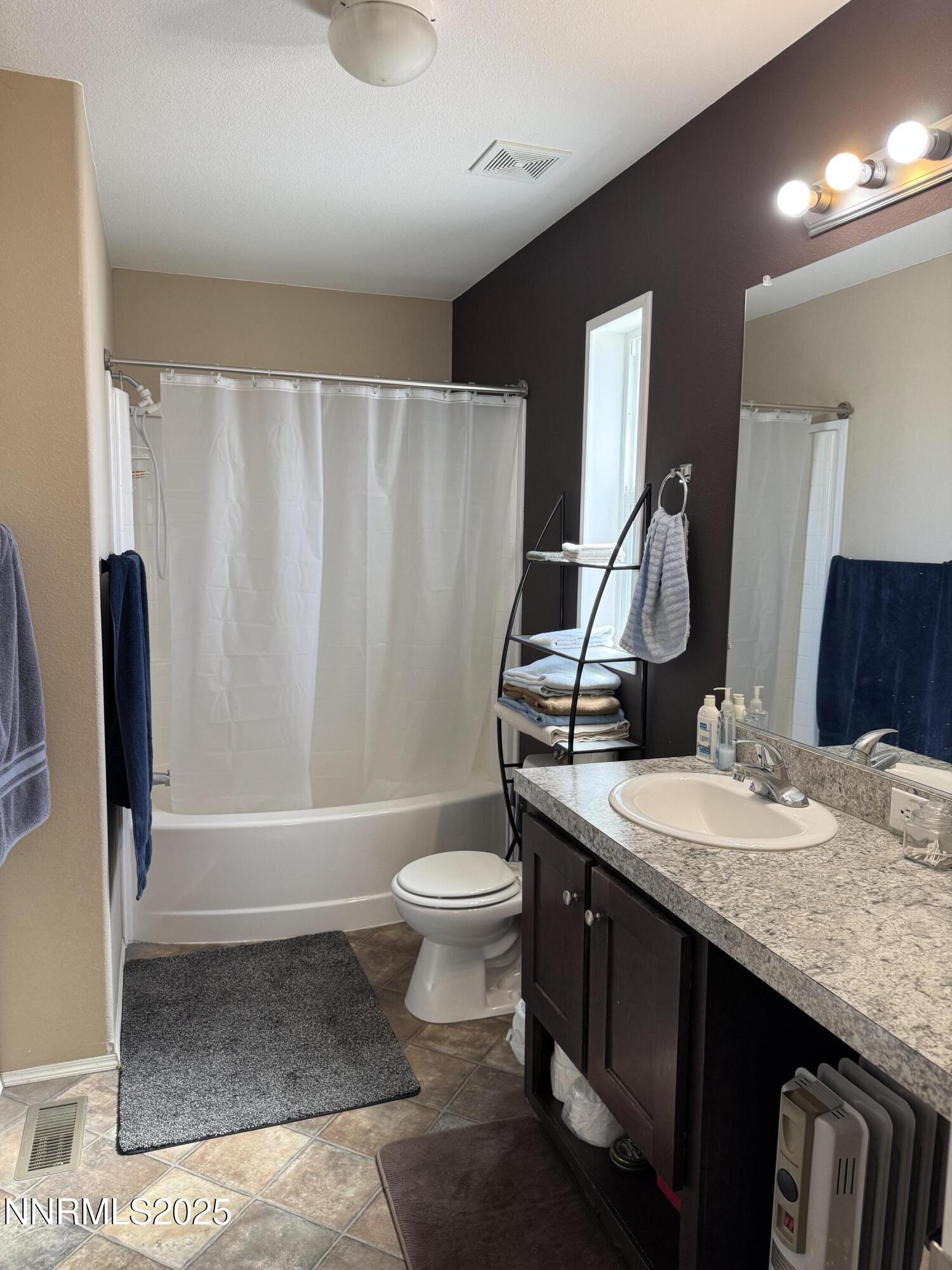 445 Mira Street Reno, NV 89521 - Photo 10 of 27 a bathroom with a granite countertop sink toilet and shower