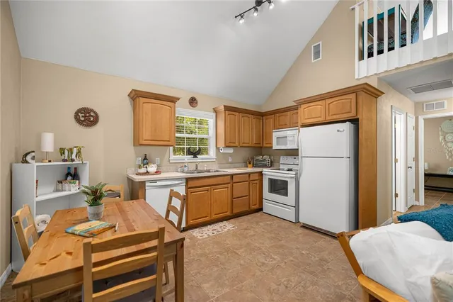 a kitchen with a sink appliances and cabinets