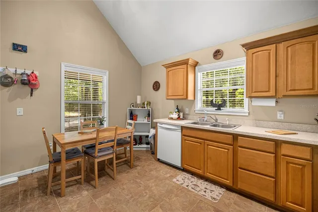 a view of a kitchen with a dining table and chairs