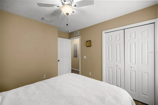 a bedroom with a large bed and a chandelier