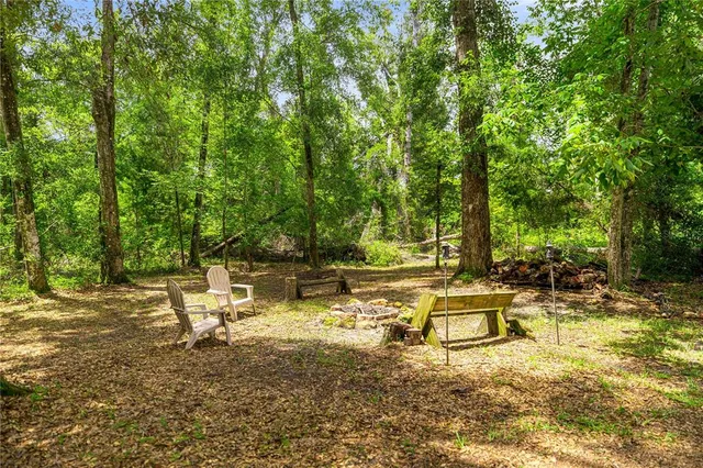 a view of a lake with a bench and trees