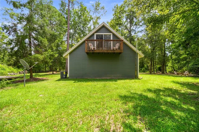 a view of backyard of house with green space