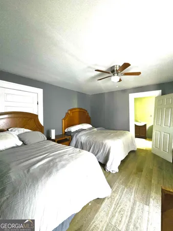 a bedroom with two beds and painted walls