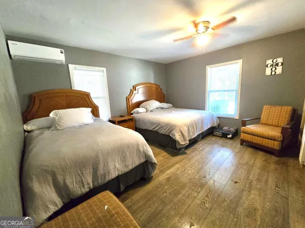 a bedroom with two beds and a chandelier