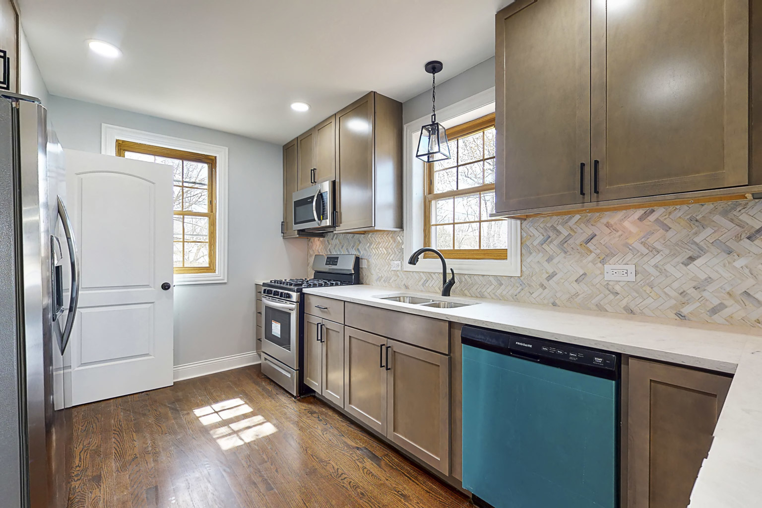 1923 186th Place Homewood, IL 60430 - Photo 18 of 39 a kitchen with a sink cabinets stainless steel appliances and a window