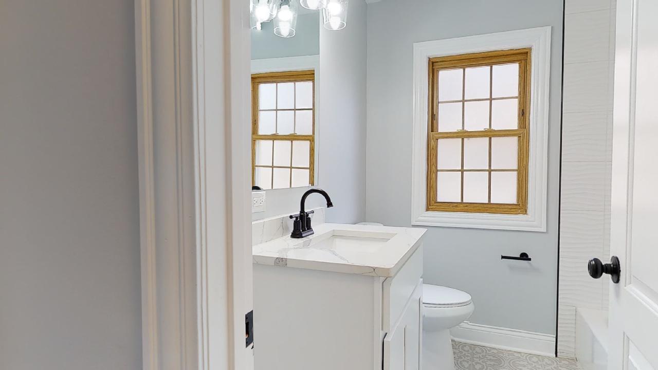 1923 186th Place Homewood, IL 60430 - Photo 20 of 39 a bathroom with a sink a toilet and a window