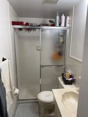 a bathroom with a toilet and a shower