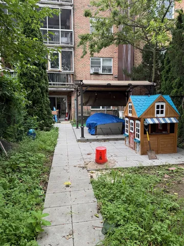 a view of swimming pool with sitting area and garden