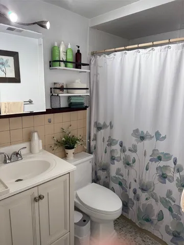 a living room with furniture a flat screen tv and a window