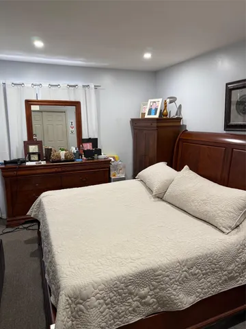 a bedroom with a bed and dresser