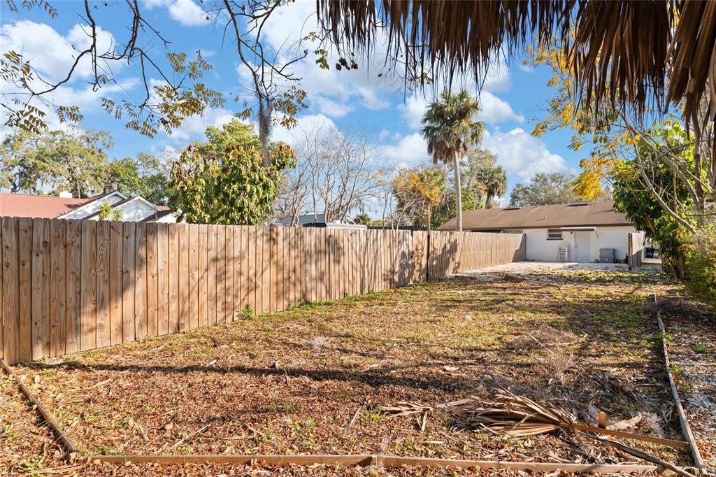 5707 Tennessee Avenue New Port Richey, FL 34652 - Photo 14 of 26 a view of a backyard with a tree