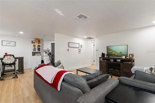 a living room with furniture a window and a flat screen tv