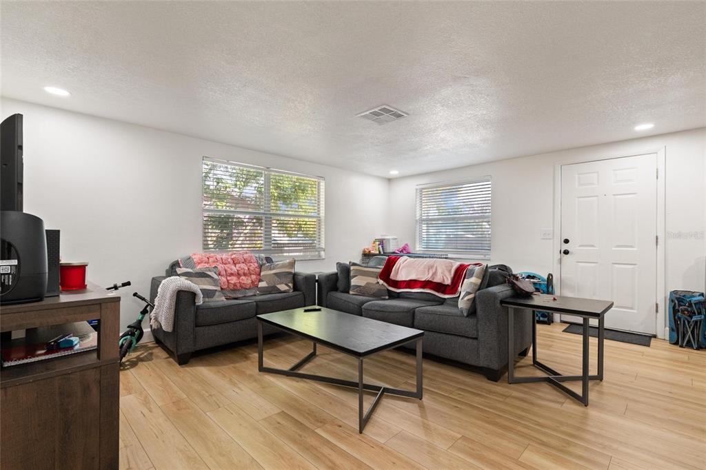 5707 Tennessee Avenue New Port Richey, FL 34652 - Photo 16 of 26 a living room with furniture a window and a flat screen tv