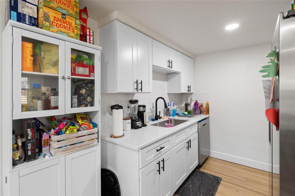 5707 Tennessee Avenue New Port Richey, FL 34652 - Photo 17 of 26 a kitchen with cabinets and window