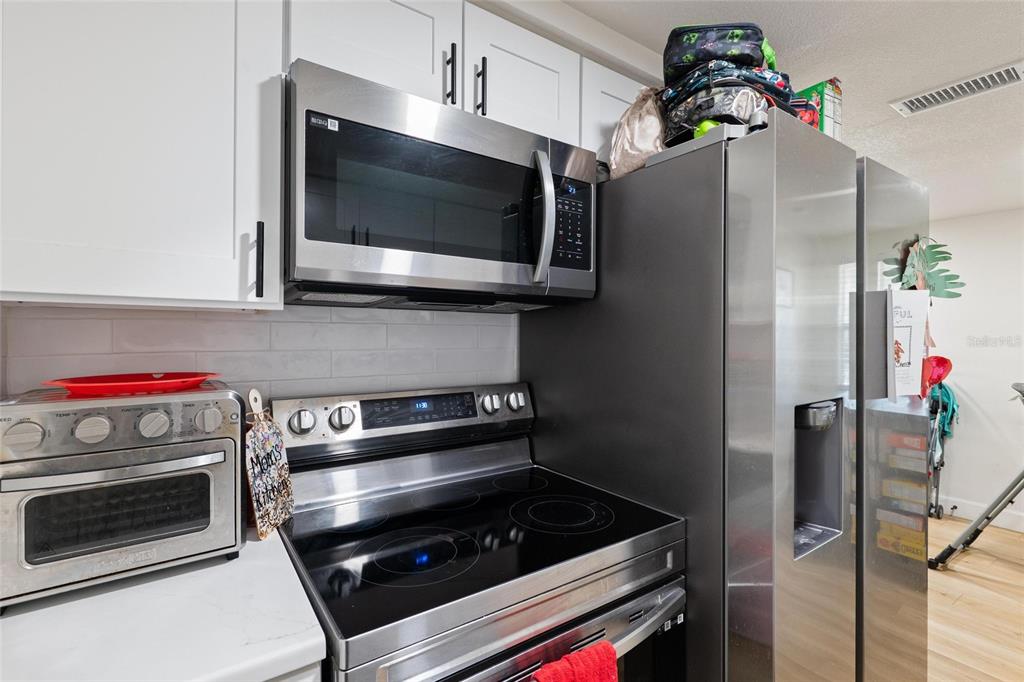 5707 Tennessee Avenue New Port Richey, FL 34652 - Photo 18 of 26 a kitchen with a stove and a microwave