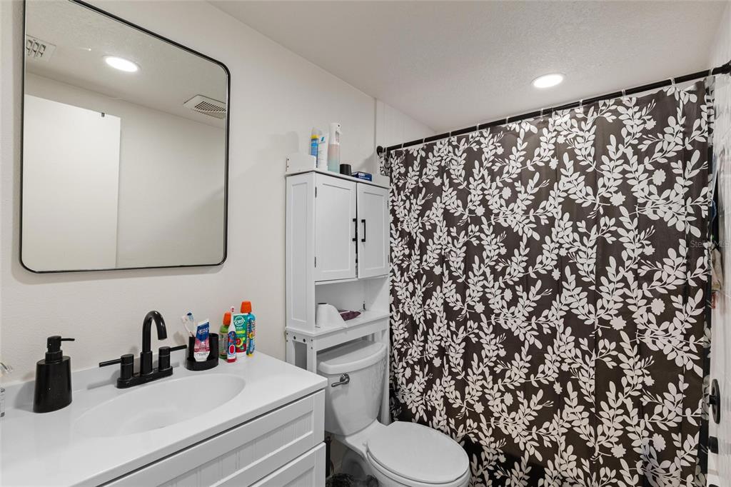 5707 Tennessee Avenue New Port Richey, FL 34652 - Photo 19 of 26 a bathroom with a sink toilet and shower