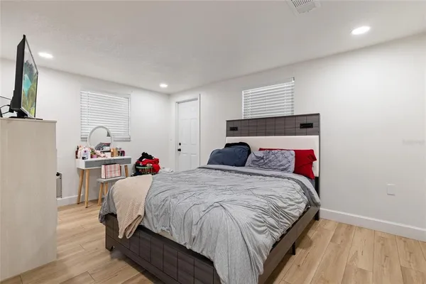 a bed room with a bed and a television