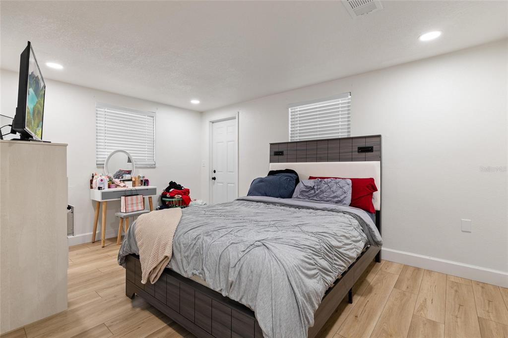 5707 Tennessee Avenue New Port Richey, FL 34652 - Photo 21 of 26 a bedroom with a bed and a flat screen tv