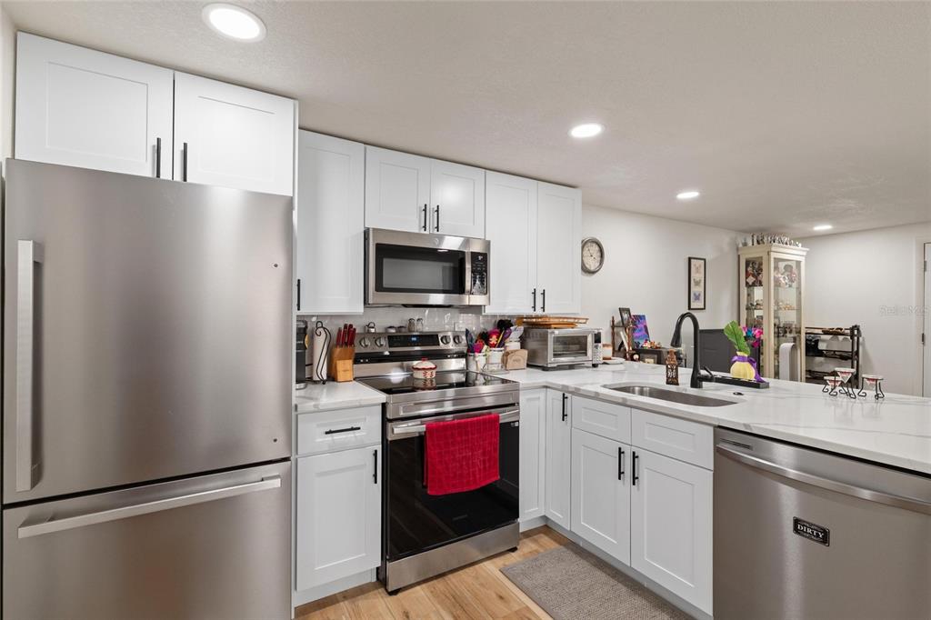 5707 Tennessee Avenue New Port Richey, FL 34652 - Photo 7 of 26 a kitchen with a sink appliances and cabinets
